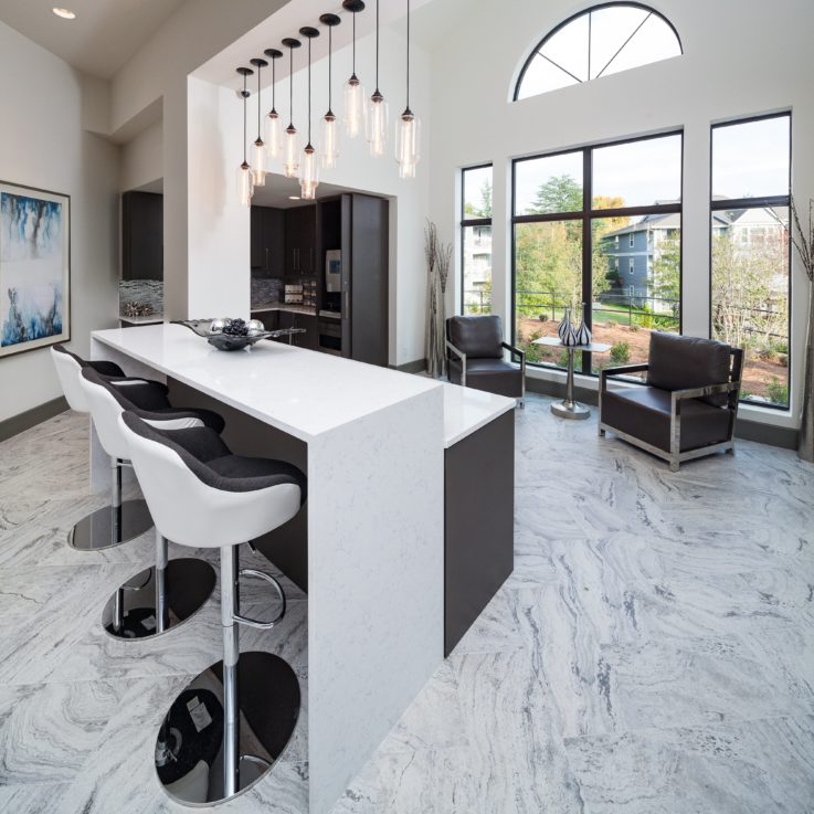 White and brown barstools with a white countertop and brown chairs