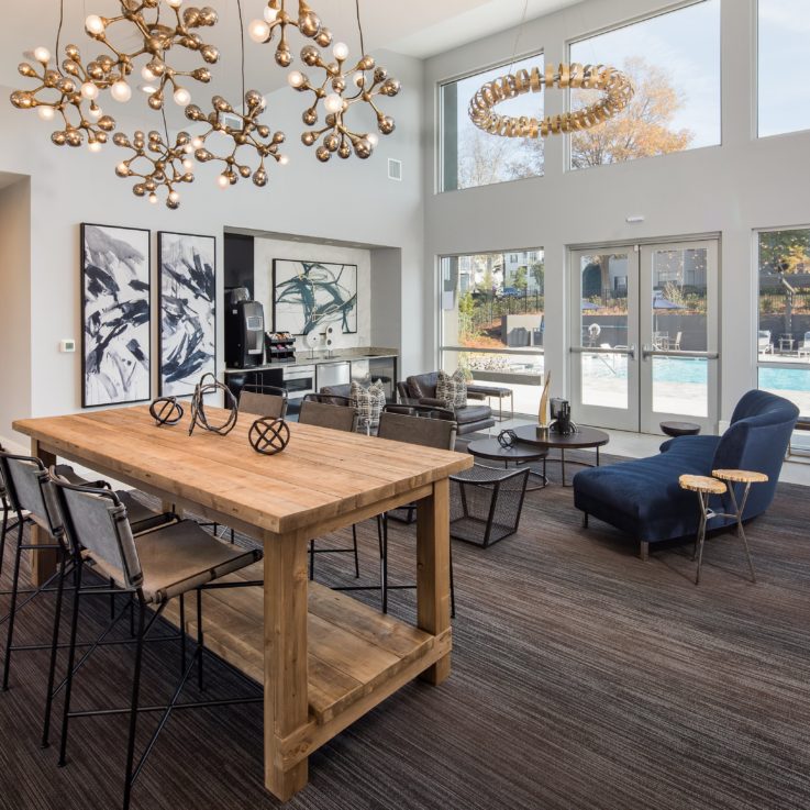 Seating and kitchen area with couches, tables, and a coffee maker