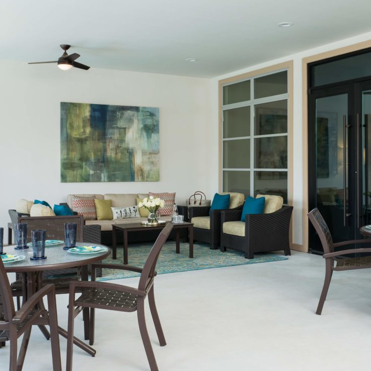 Indoor dining and seating area with an open door to outside