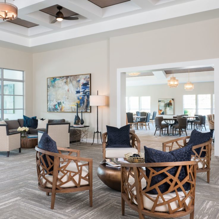 Seating area with wooden chairs and white and blue cushions