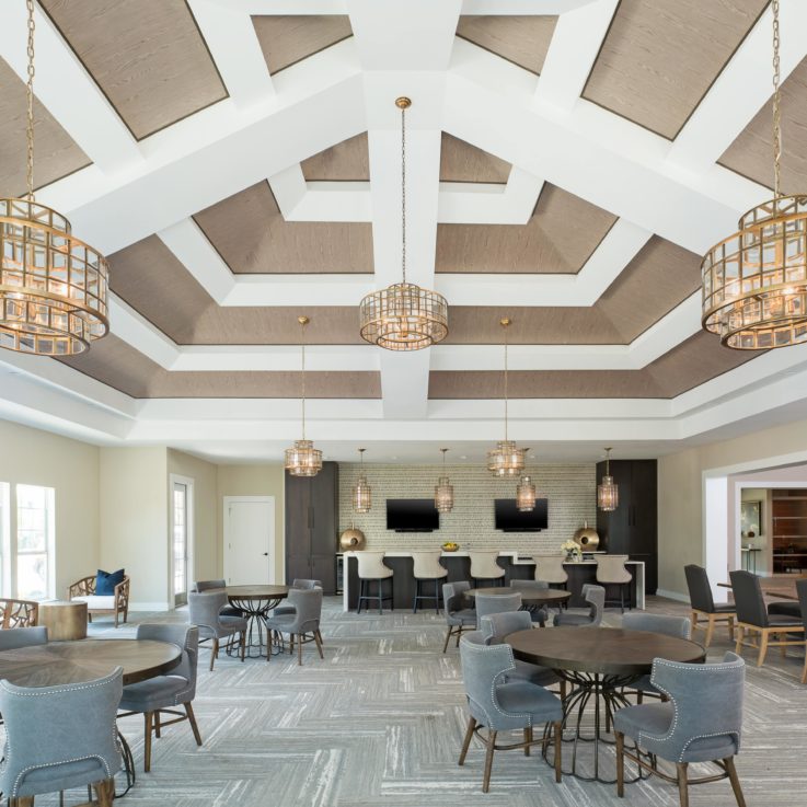 Dining area with a high ceiling and three hanging lights