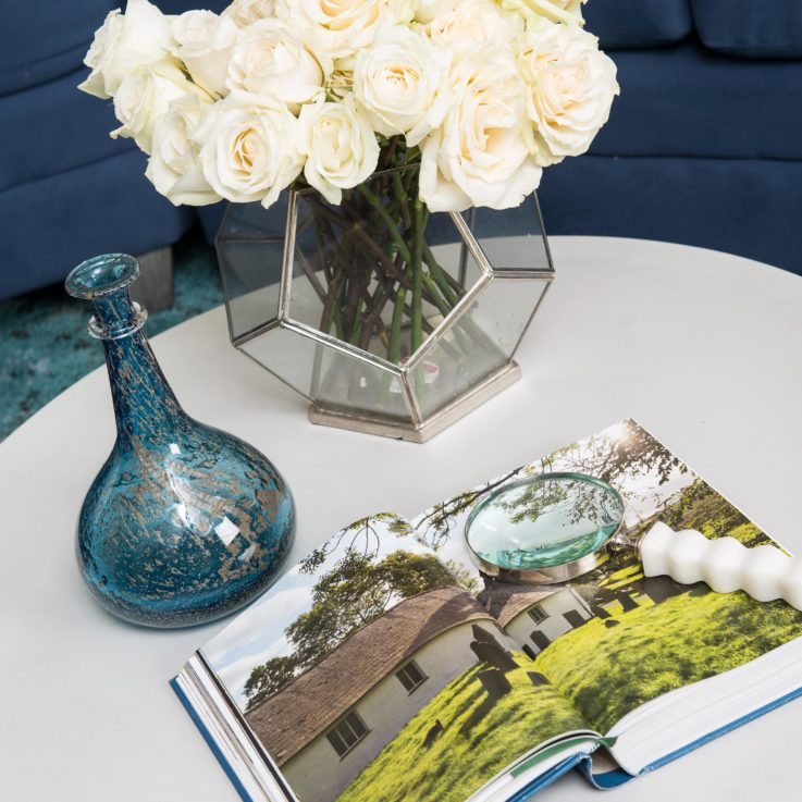 White table with a book and magnifying glass