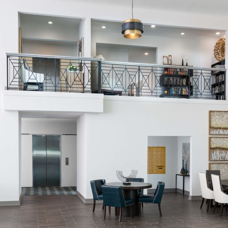 Indoor balcony above a seating area with a hanging light