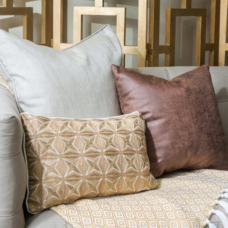 Closeup of three different cushions on a couch