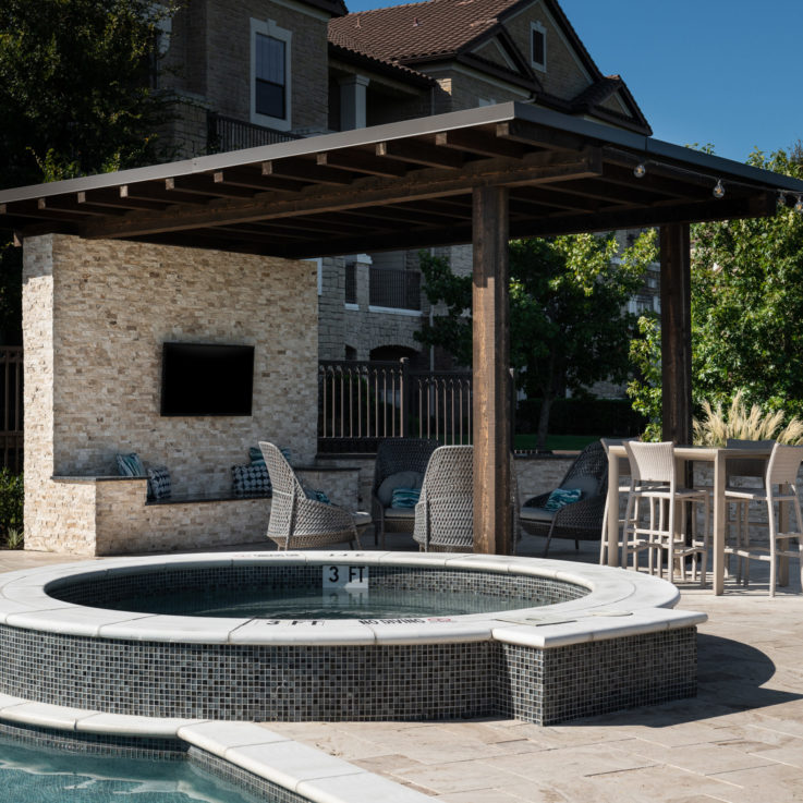 Circular hot tub next to the main pool