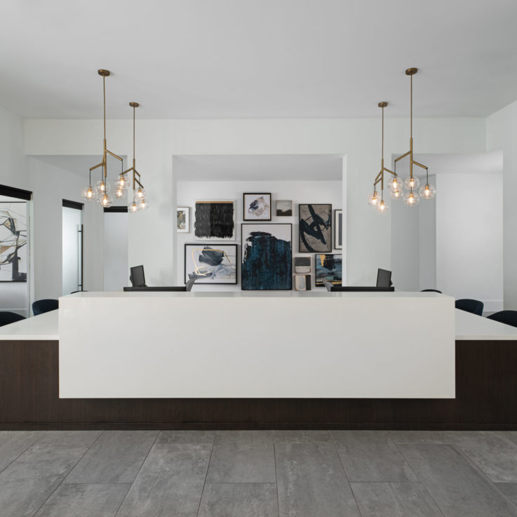 Working area with white desks surrounded by offices