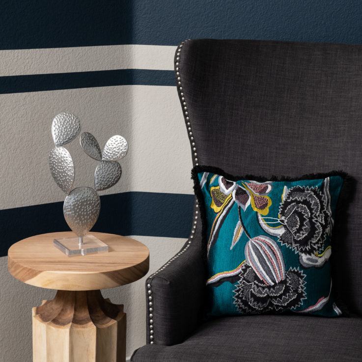 Closeup of a gray chair next to a wooden endtable