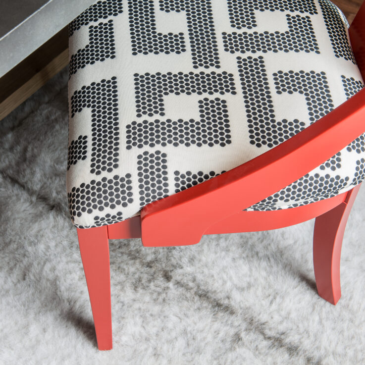 Orange chair on a white fur rug