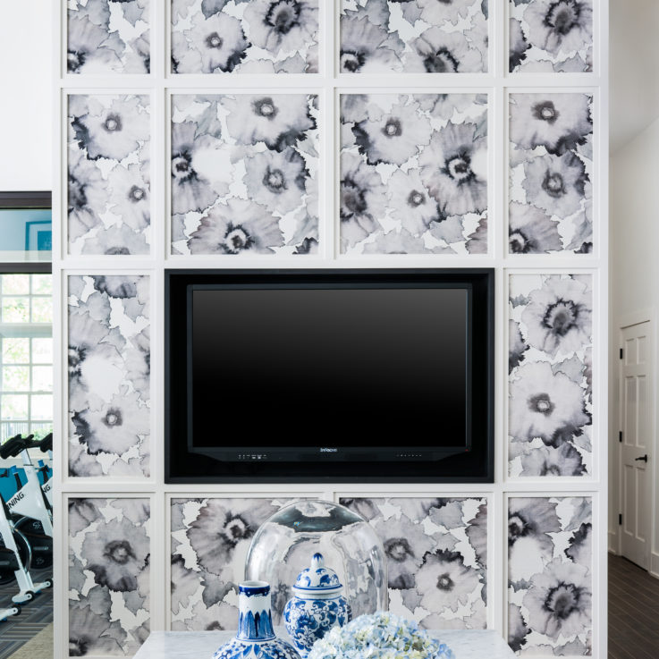 Flatscreen television on a flower patterned wall