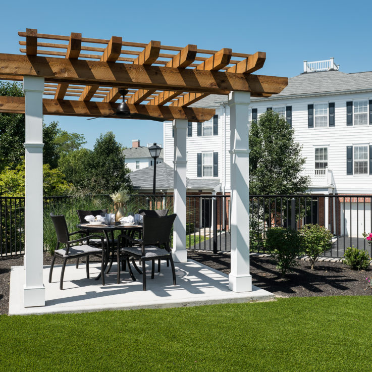 Outdoor dining table with four black chairs