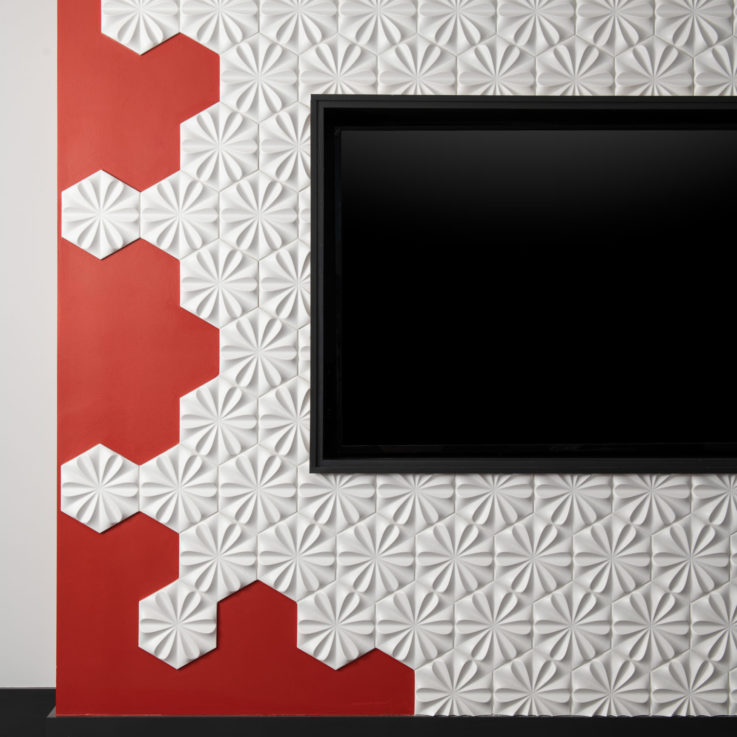 Flatscreen television mounted on a red and white wall