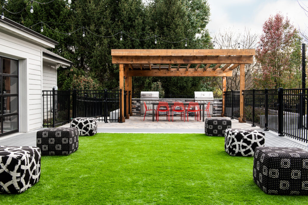 Outdoor seating area on the grass with two grills