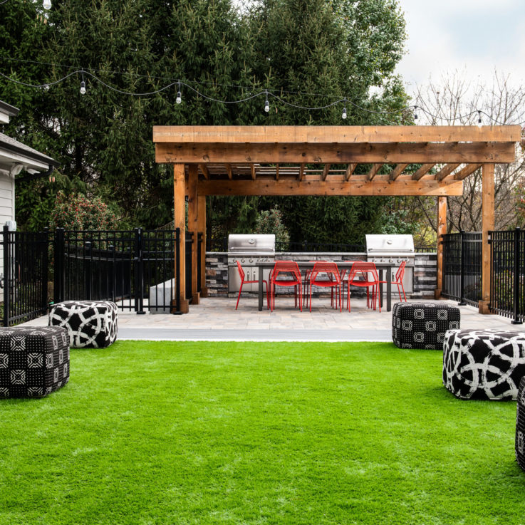 Outdoor seating area on the grass with two grills