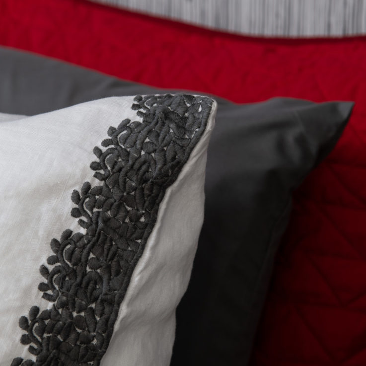 White, dark gray, and red pillows