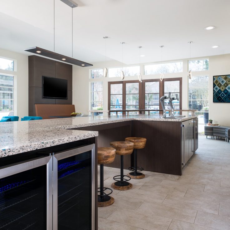 Bar area with wooden barstools and white countertops