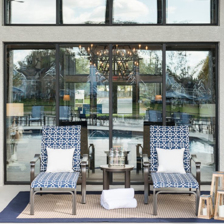 Brown, blue, and white beach chairs in front of a window