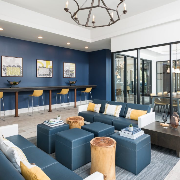 Seating area with white and blue cushions with glass w