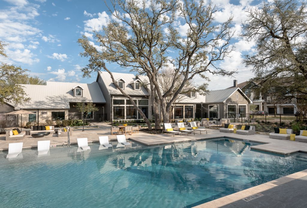 View of the pool with the house behind it