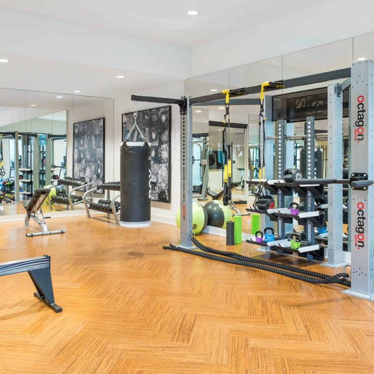 Workout room with a wood floor and wall mirrors