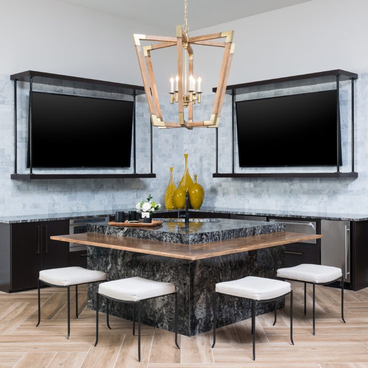 Marble bar area with two large flatscreen televisions