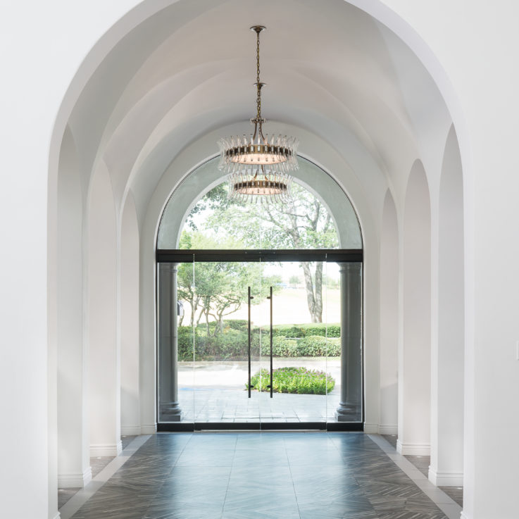 Arches in a front foyer with glass front doors