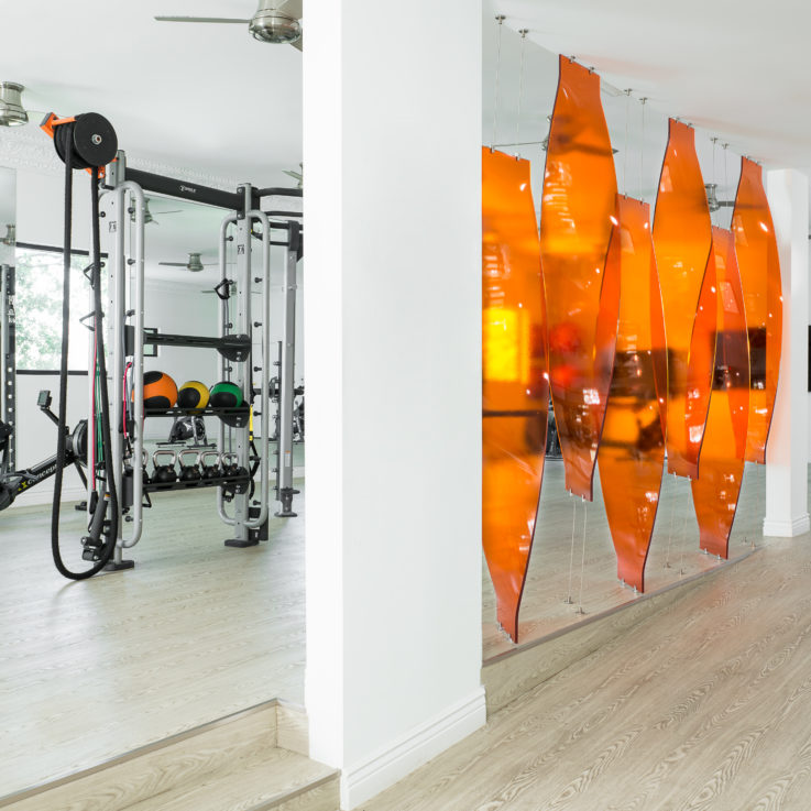 Workout machines near an orange art fixture