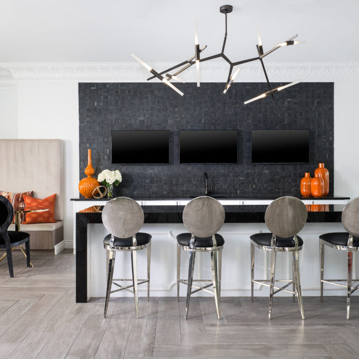Bar area with three flatscreen televisions and four barstools