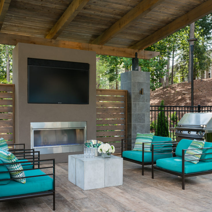 Outdoor seating area with black chairs and teal cushions
