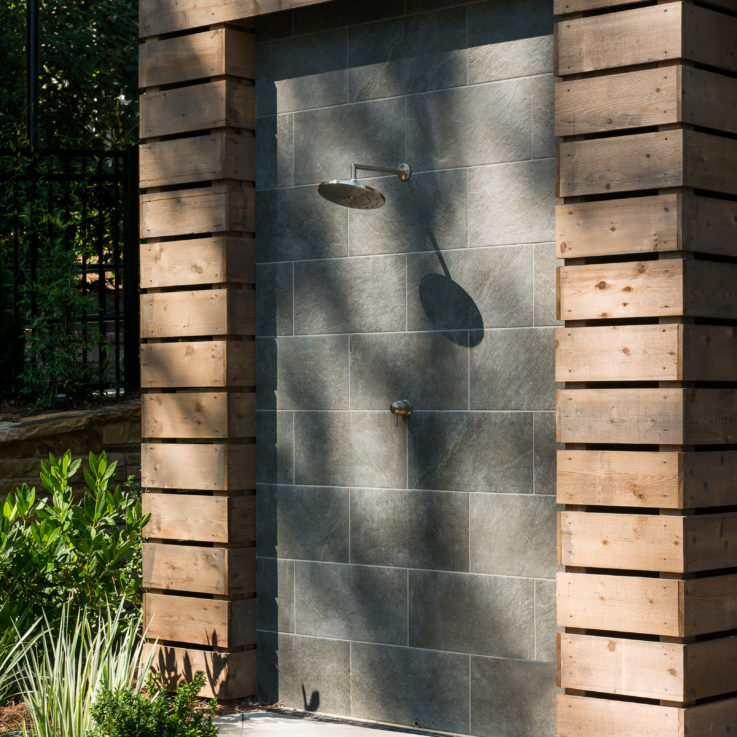 Outdoor shower with dark tiles