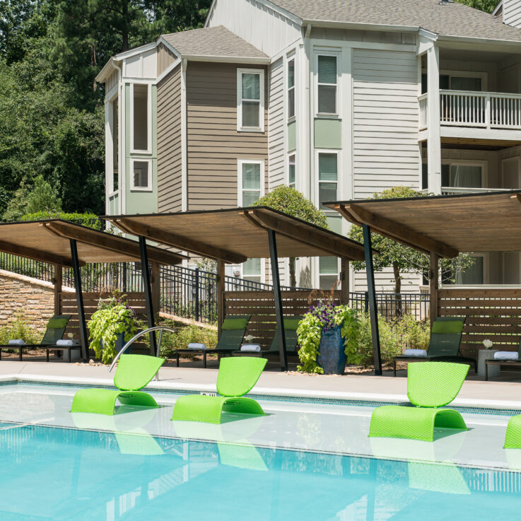 Green seats in a very shallow section of the pool