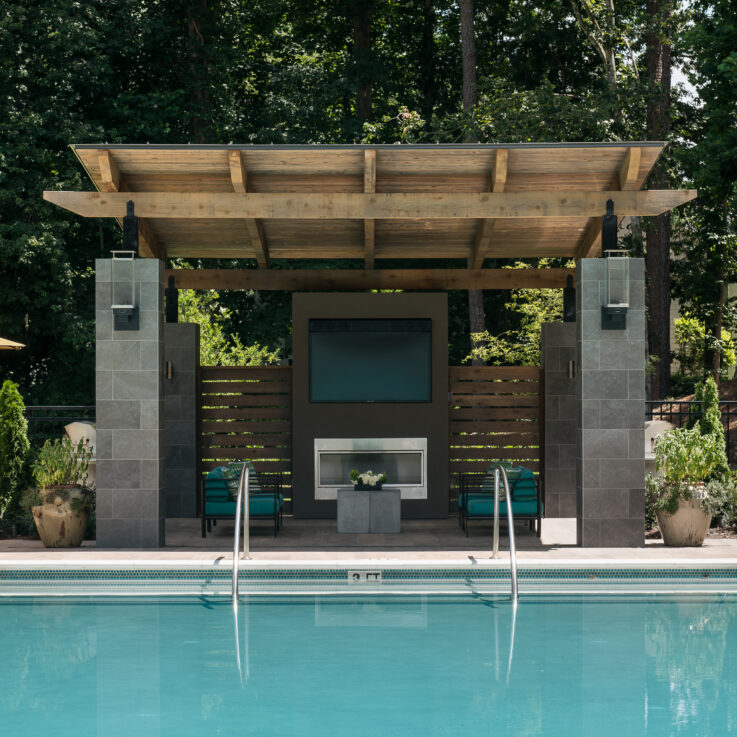 Covered seating area behind a pool