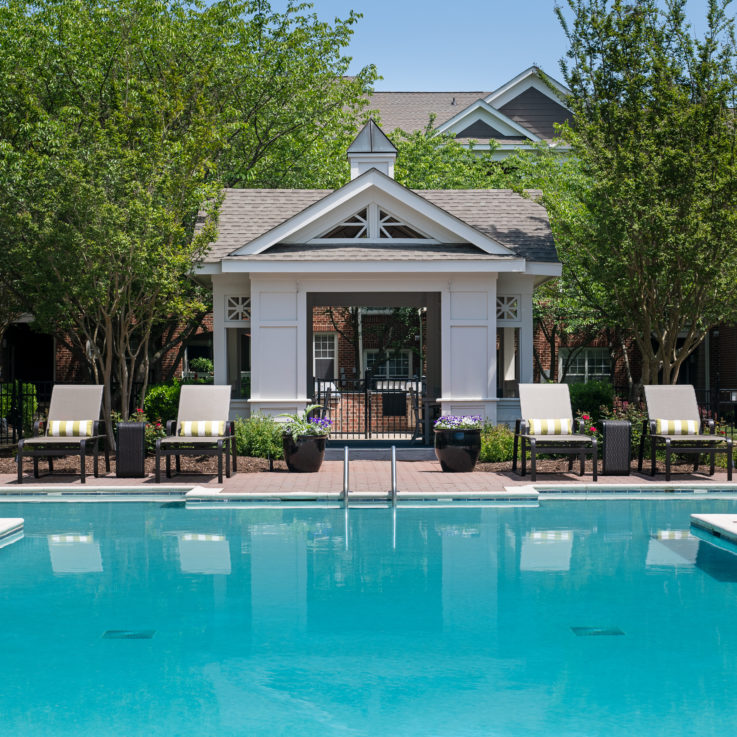 Outdoor pool with four beach chairs