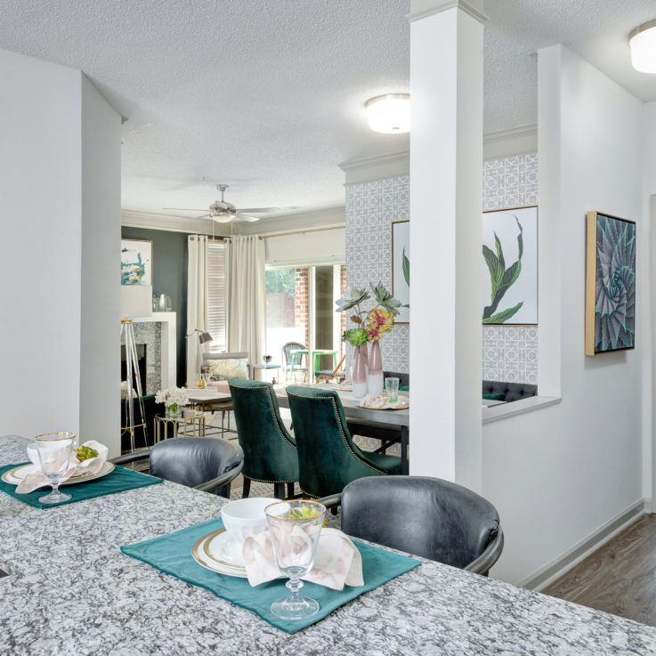 Dining and living areas next to the kitchen with glass doors to the balcony