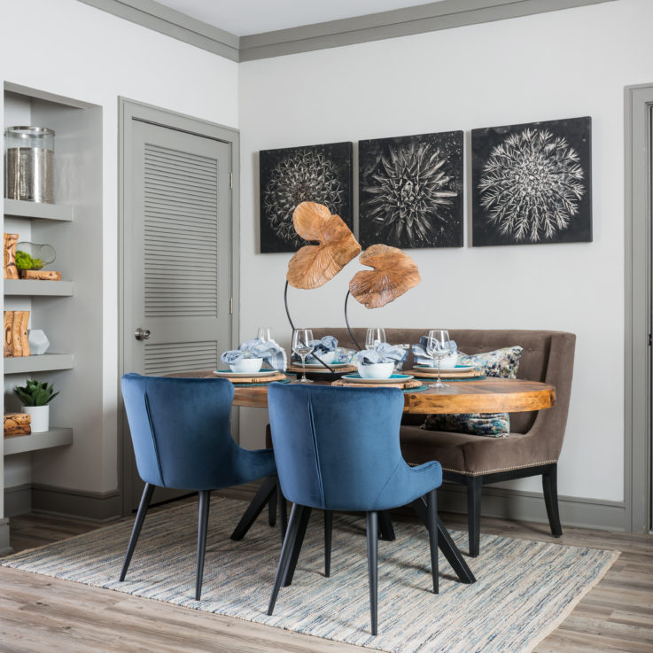 Wooden dining table with a brown bench and blue chairs