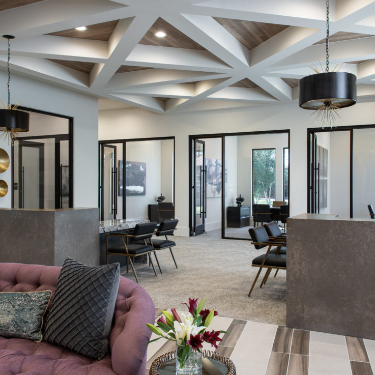 Indoor seating area with various offices with glass walls