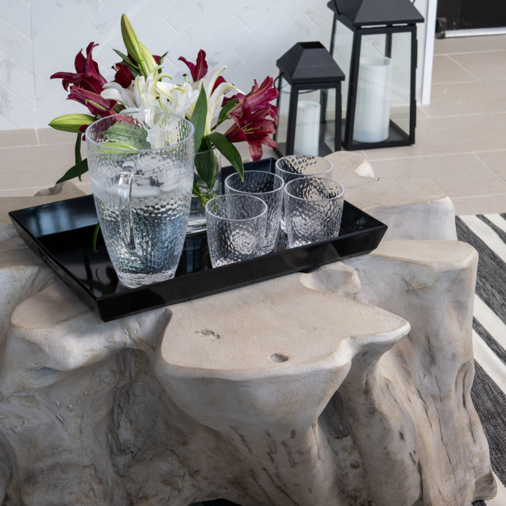 Unique table with a black tray filled with water glasses