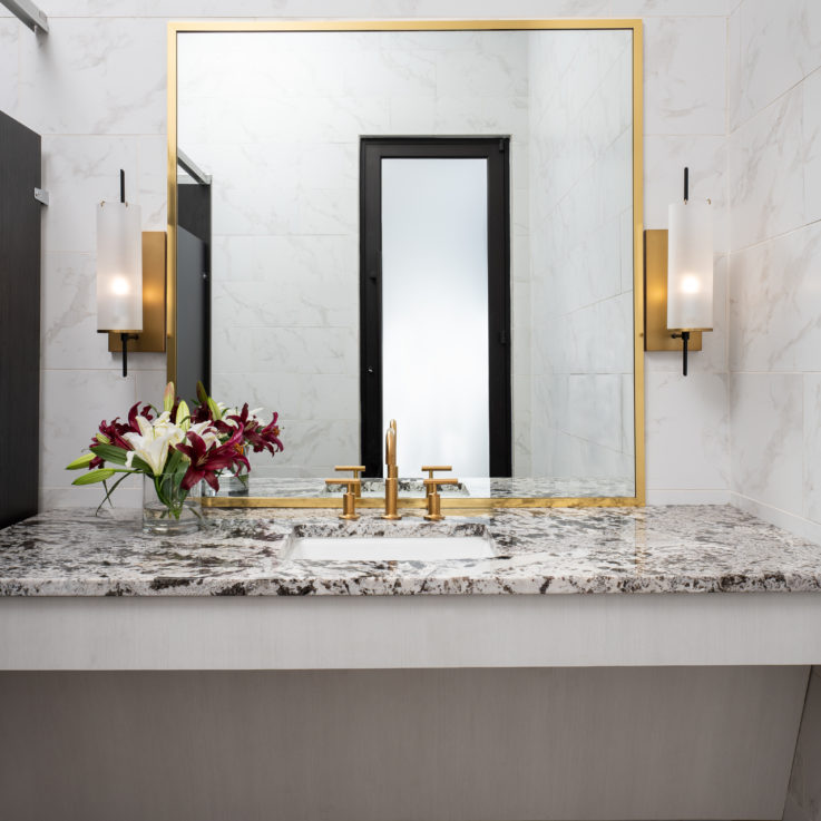 Bathroom sink with granite countertop and large mirror