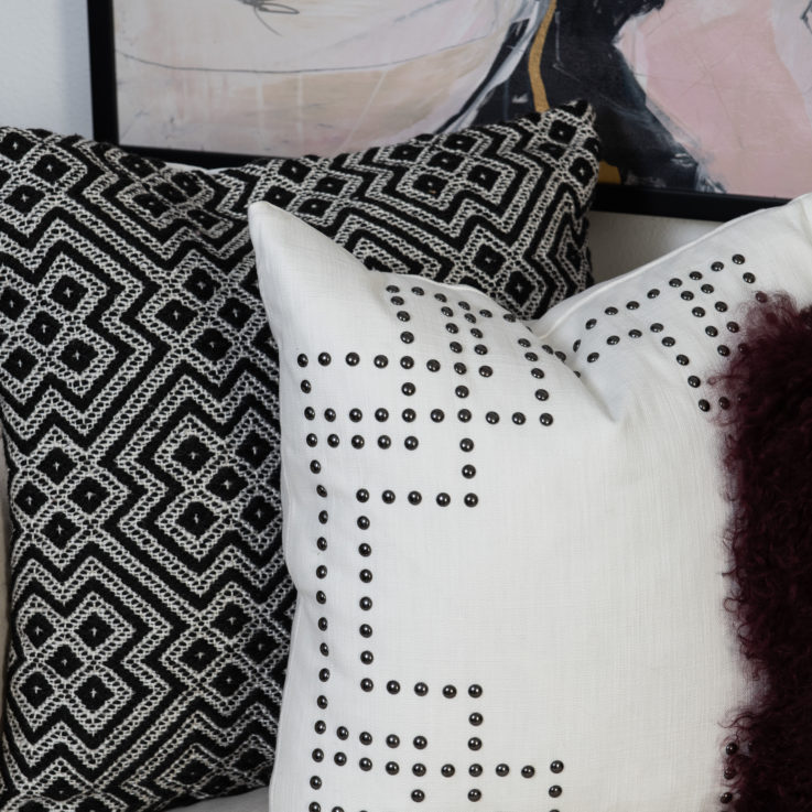 Closeup of a purple, white, and black pillows
