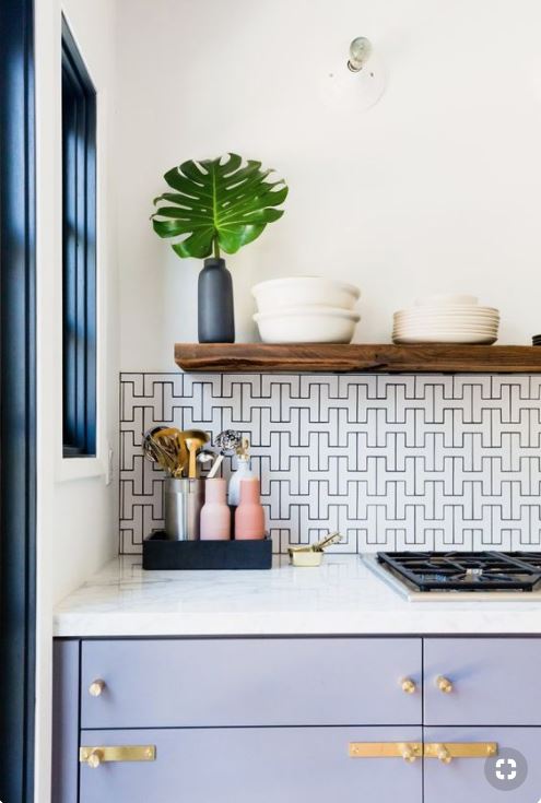 Kitchen with white walls and countertops with blue accents and blue cabinets