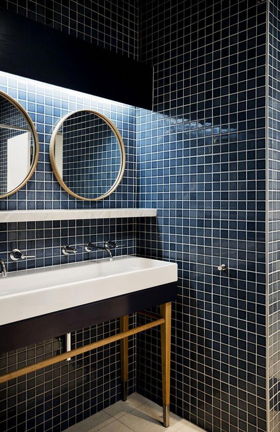 Bathroom with white sinks and blue square tiles on the wall