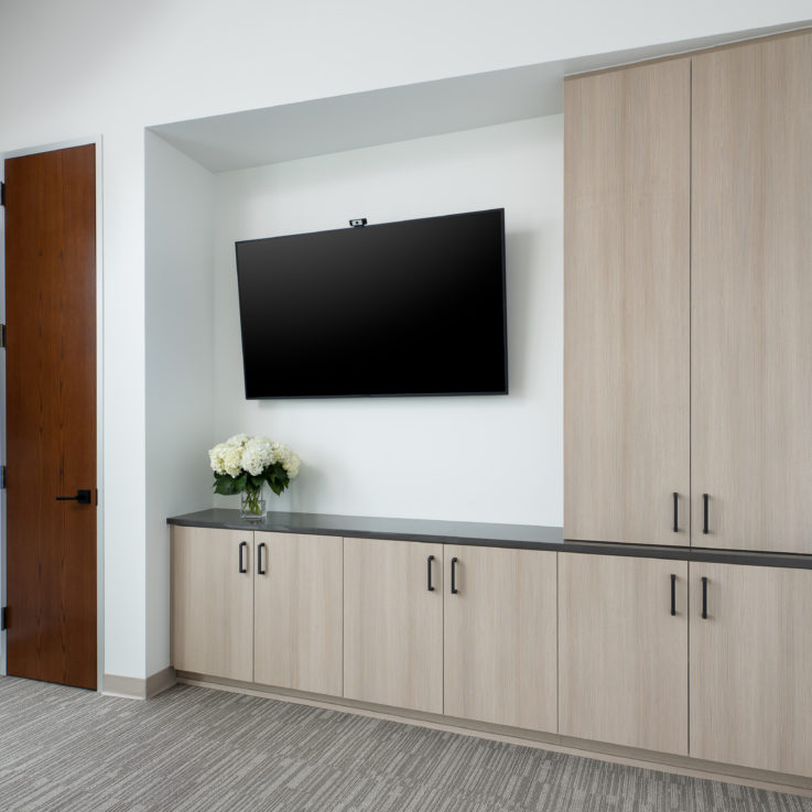 Light brown cabinets with a flatscreen television