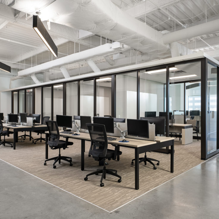 Shared work environment with desks, chairs, and computers