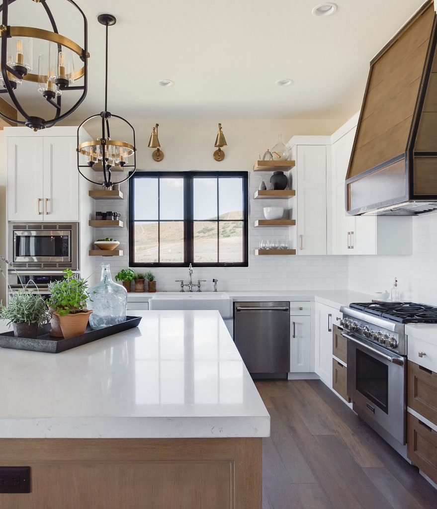 Kitchen with white cabinets, white countertops, and a window