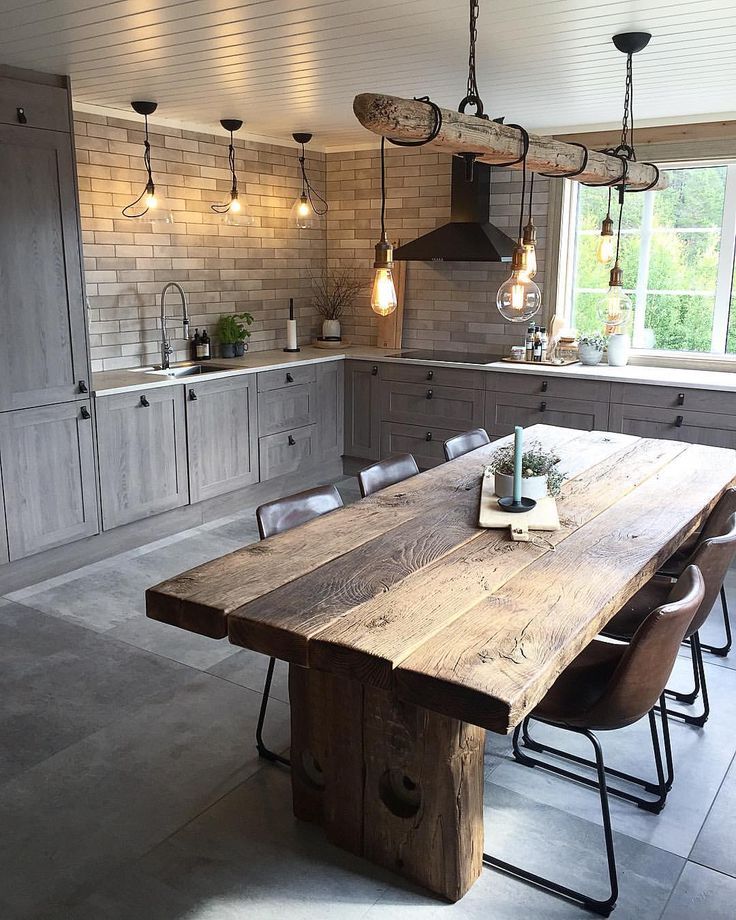 Kitchen with wooden cabinets, brick walls, and a wooden table