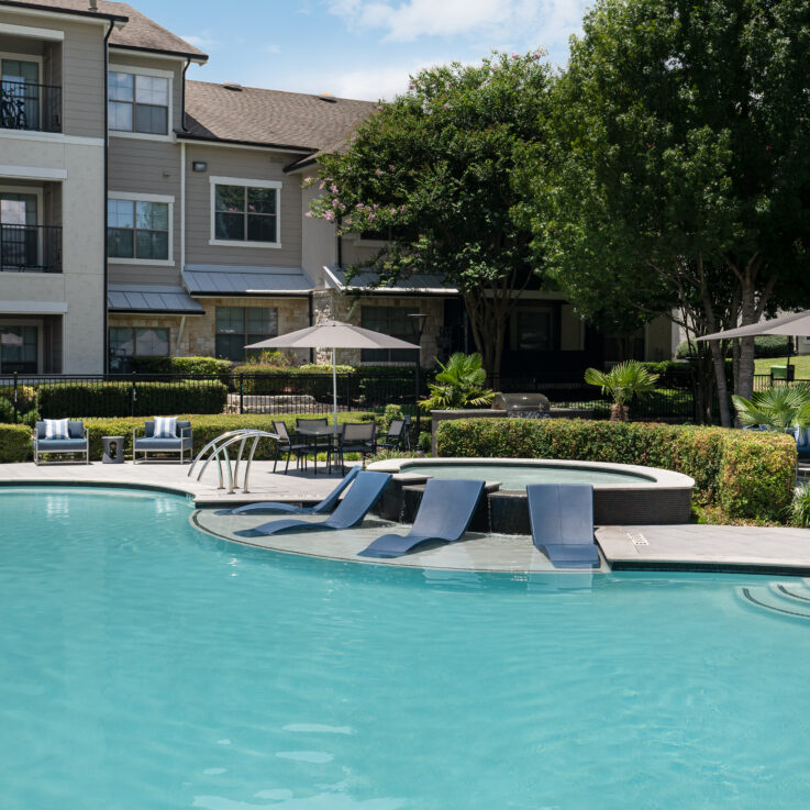 Outdoor pool, hot tub, and seating with umbrellas