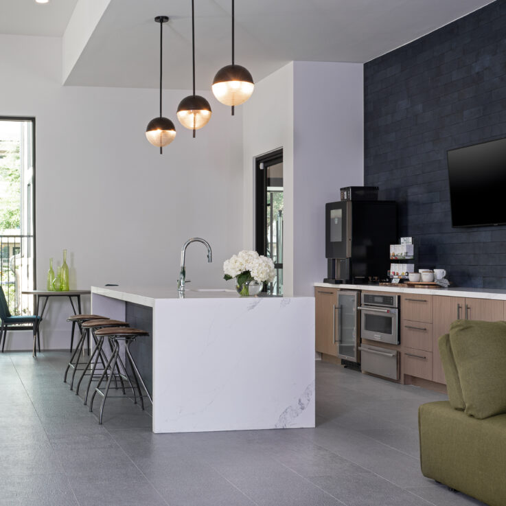 Kitchen area with white countertops, a coffee maker, and a mini-fridge