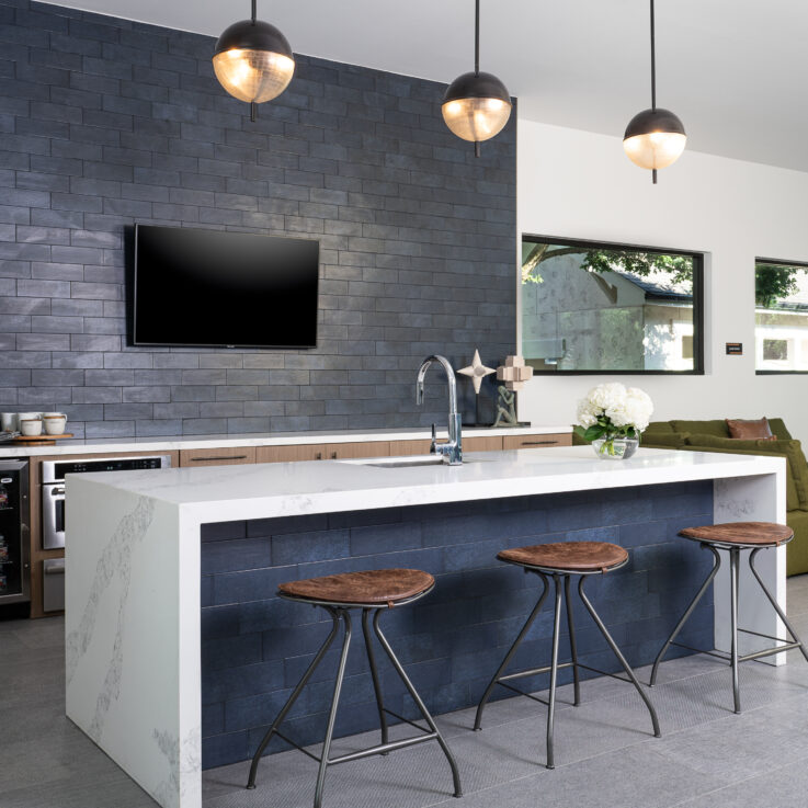 Kitchen area with a coffee maker and mini-fridge next to a seating area