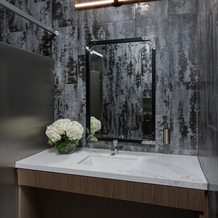 Bathroom sink with white countertop and dark blue walls