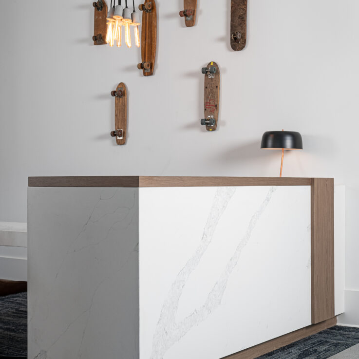 Wooden skateboards hanging on a wall above a white desk