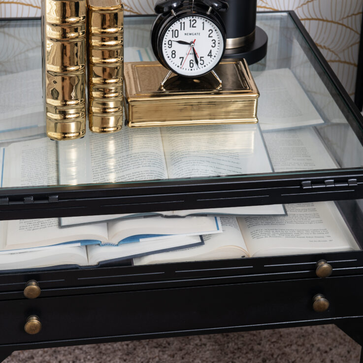 Nightstand with a glass top filled with books